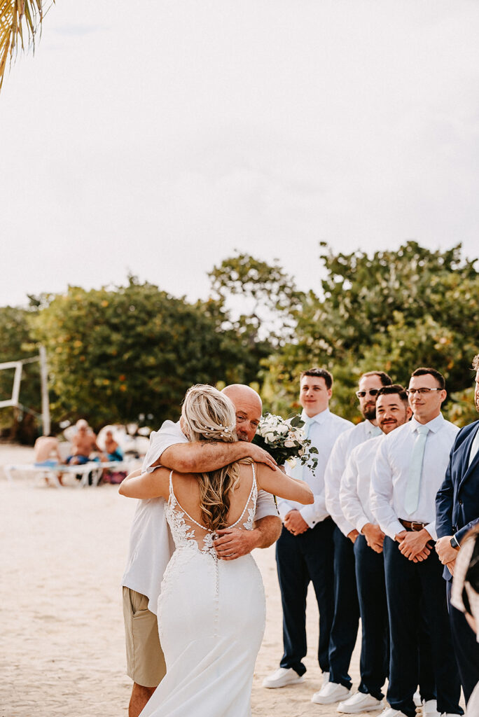 bride hugging dad at ceremony on sapphire beach resort in st thomas usvi