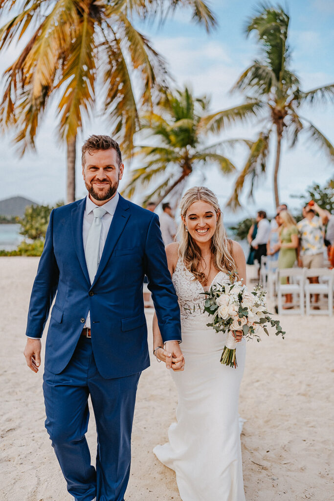 bride and groom joyfully smiling after beach wedding is finished