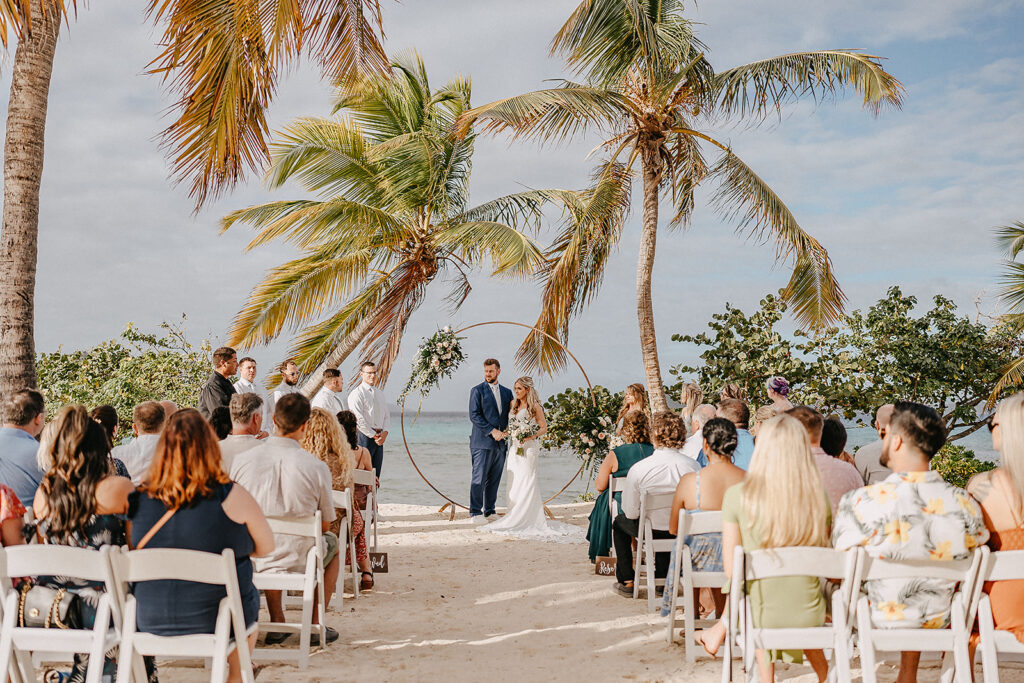 bride and groom reading vows at beach ceremony on sapphire beach in st. thomas