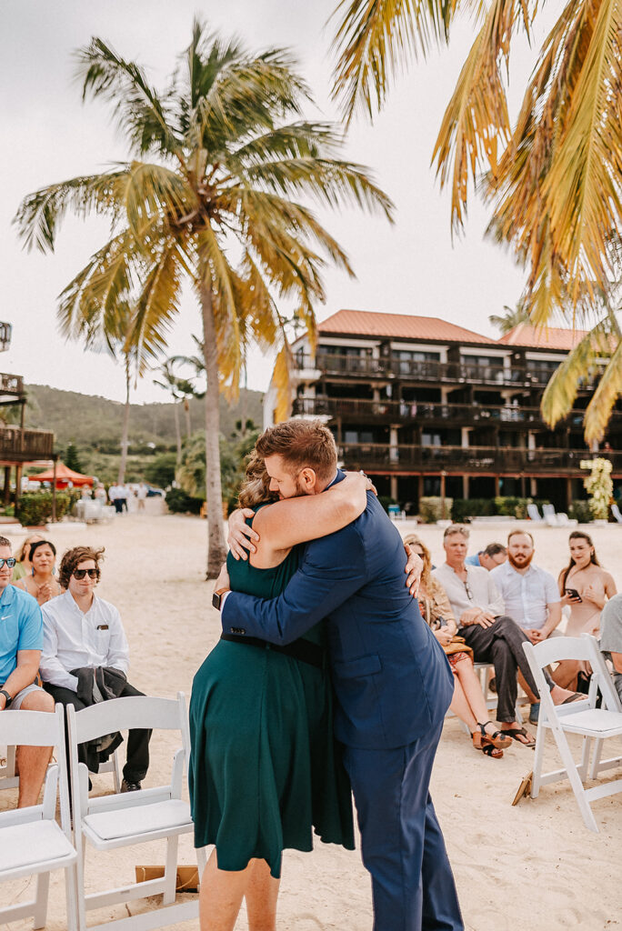 groom hugging mom at sapphire beach resort for usvi wedding 