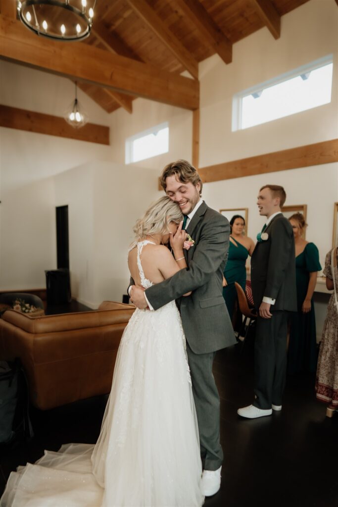 groom comforting bride after their ceremony at ivy black 