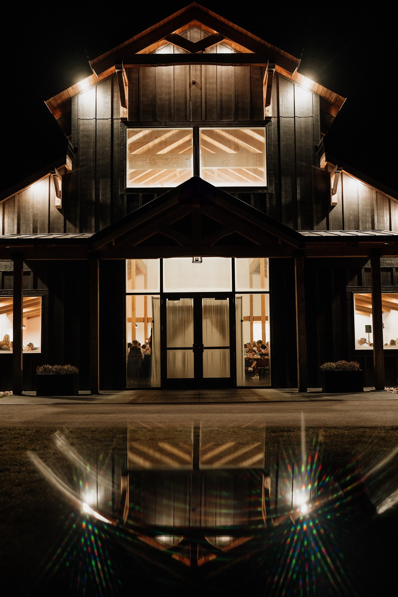 night photo of ivy black barn