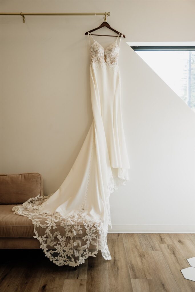 dress hanging in juniper suite at pinewood wedding and events