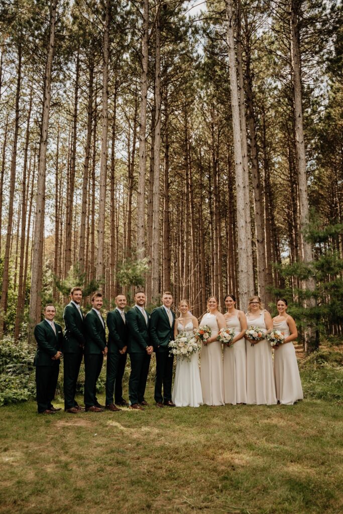 Wedding party with tall pines at pinewood