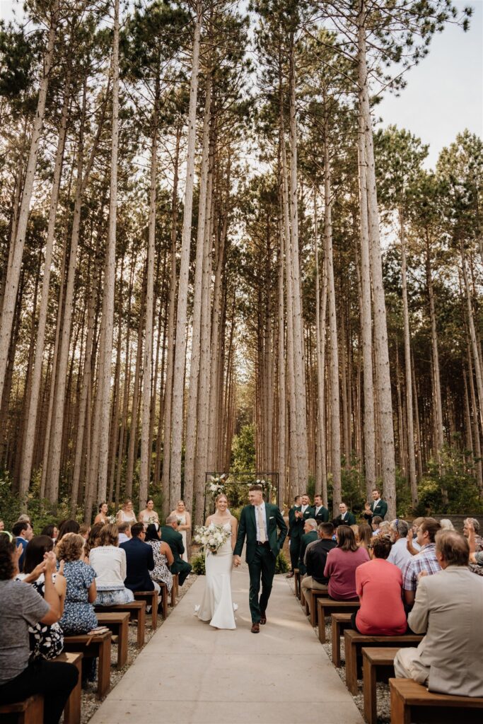 walking back up the aisle at outdoor ceremony at pinewood